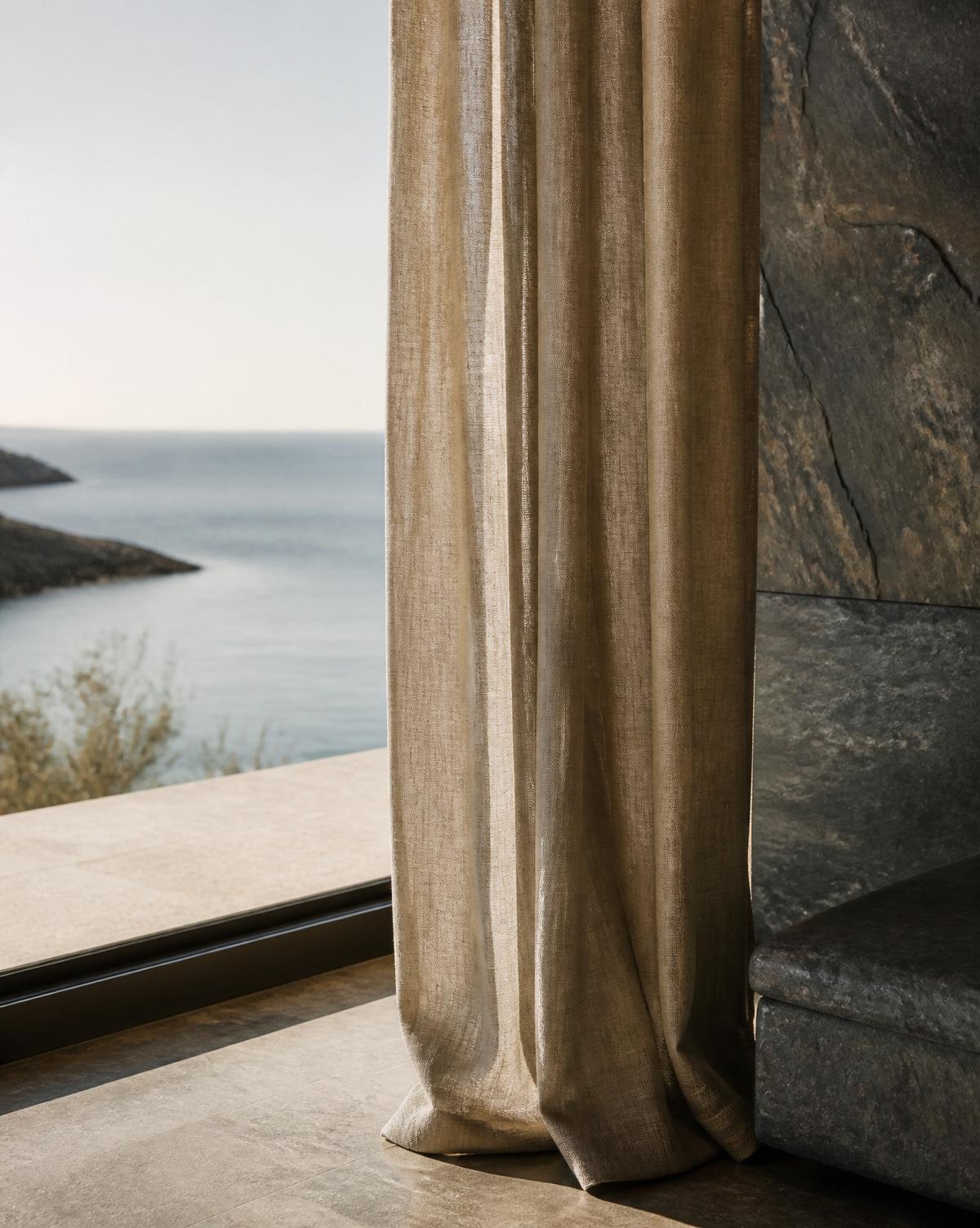 Linen curtain over a slate wall with a view of the Baltic Sea